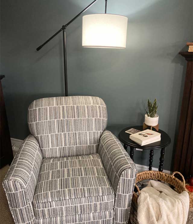 Woman Watching book in a place of honour beside the chair